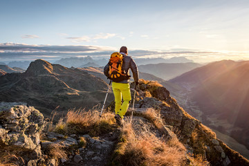 mountaineer hiking in the mountains in morning light