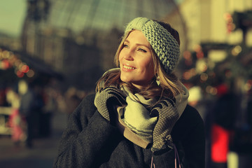 Dreaming woman in winter city a festive mood