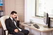 © DC Studio - Businessman talking on the phone and working in the office. Businessperson in professional environment