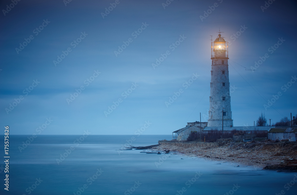 Seascape at sunset. Lighthouse on the coast - obrazy, fototapety, plakaty 