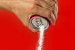 man hand holding refresh drink can pouring sugar stream in sweet and calories content of soda and energy drinks