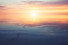 Scenic Ocean Sunset Over The Calm Water Surface