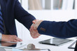 © rogerphoto - Business handshake at meeting or negotiation in the office. Partners are satisfied because signing contract or financial papers