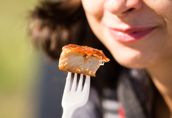 the girl eats meat in the nature