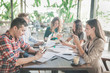 © Odua Images - business people busy on their gadget during team meeting