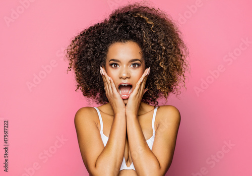 Fotografia, Obraz Surprised beautiful black woman holds cheeks by hand