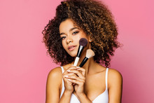 Portrait Of The Beautiful Black Woman With Make-up Brushes Near Attractive Face