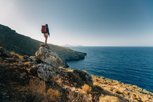 Female Hiker On A Rocky Outcrop Overlooking A Sea View In Kalymnos, Greece