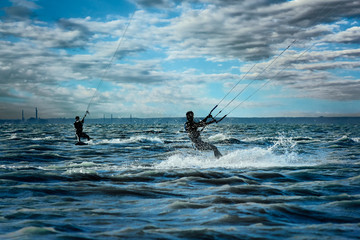 Two surfers rushing through the sea, close-up