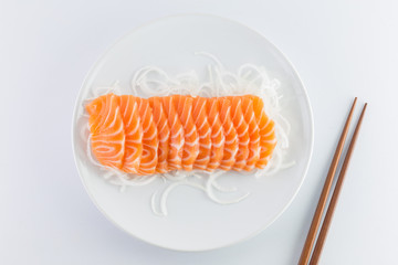 salmon sashimi, raw on a plate on a white background