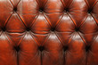 © Marcel/Stocksy - Red leather couch detail