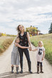 © Carey Shaw/Stocksy - Modern family standing on rural road