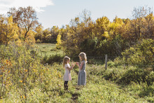 Young Girls Playing In Autumn Field