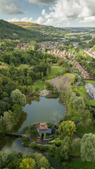 Wall Mural - a small lake surrounded by trees in ebbw vale, south wales viewed from the air