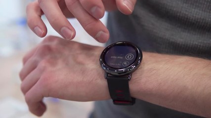Man's hand touches the screen smart watch