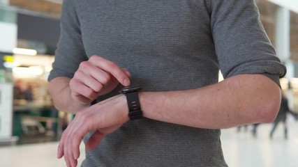 Man's hand using smartwatch, steadicam shot