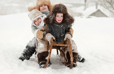 Wall Mural - Children slide down hills on sleds