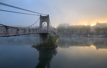 Pedestrians On A Footbridge Over The Rhone River In Lyon, On  A Foggy, Autumn Morning.