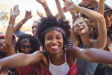 Cheerful Young Woman Enjoying At Music Festival