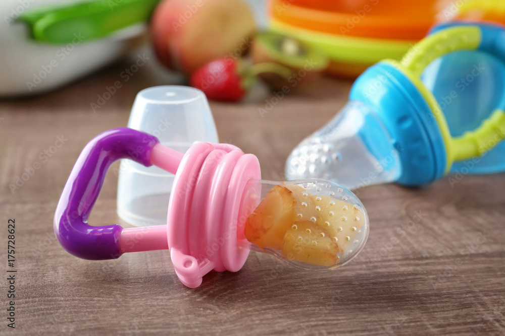 Baby's nibbler on wooden background