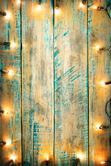 Christmas lights bulb on wood table. Merry christmas (xmas) background. topview, border design - rustic and vintage styles