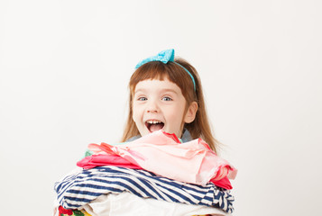 Girl experiencing delight with clothes in hands