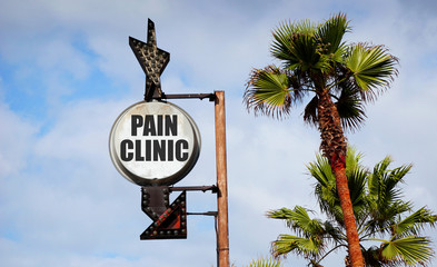 Wall Mural - pain clinic sign with palm trees