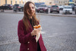 © Khanykov - the girl on the street holding a cakes and laughs
