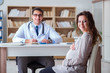 © Elnur - Pregnant woman visiting doctor for consultation
