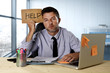 © Wordley Calvo Stock - businessman suffering stress working at computer desk holding sign asking for help looking tired exhausted