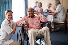 Portrait Of Cheerful Disabled Senior Man Sitting On Wheelchair