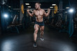 © antondotsenko - Handsome model young man training legs in gym