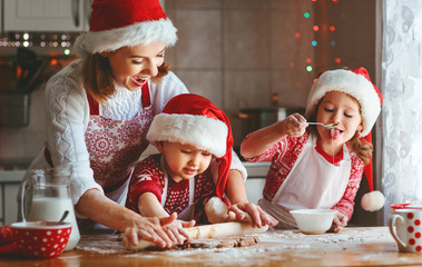 happy family mother and children  bake cookies for Christmas