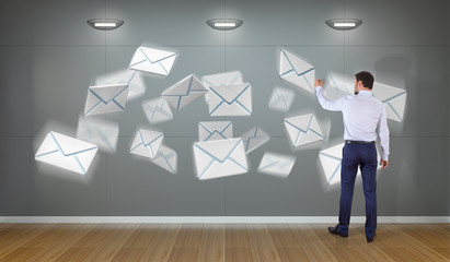 Wall Mural - Businessman using email interface on a wall 3D rendering