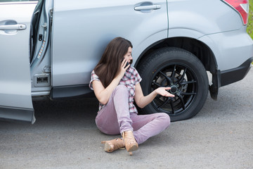 Wall Mural - Woman With Flat tire On Car Phoning For Assistance