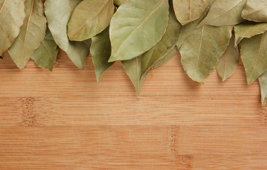 Wall Mural - dry bay leaf on a wooden kitchen cutting board