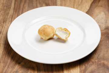 profiteroles on plate closeup one sliced