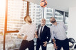 © VadimGuzhva - Three businessmen play football in the office with an orange soccer ball. They are having fun
