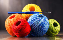 Colorful Yarn For Crocheting And Hook On Wooden Table