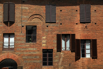 Sticker - old windows with shutters on medieval red brick textured wall, Italy.