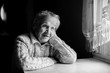 © De Visu - Black and white contrast portrait of an elderly woman.