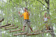 © auremar - Man walking along rope bridge