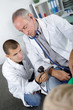 © auremar - older doctor training young doctor on measuring pressure