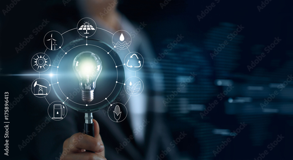 Man holding magnifying glass and light bulb ,searching global show the world's consumption with icons energy sources Ecology concept - obrazy, fototapety, plakaty 