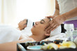 © Johnstocker - Young beautiful woman having face massage relaxing in spa.