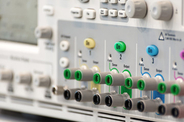 Wall Mural - Fragment of a modern digital oscilloscope. Connector and regulator panel.