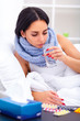 Health Care. Closeup Of Beautiful Ill Woman With Headache, Sore Throat And Fever Covered In Blanket Feeling Sick, Measuring Body Temperature With Thermometer. Sickness And Illness. High Resolution