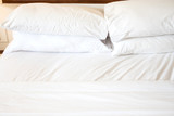 Fototapeta  - White pillows and Comfortable soft  on the bed.