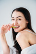 © LIGHTFIELD STUDIOS - Smiling woman eating slice of cucumber