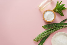 Aloe Vera And Cosmetic Ingredients On Pink Background